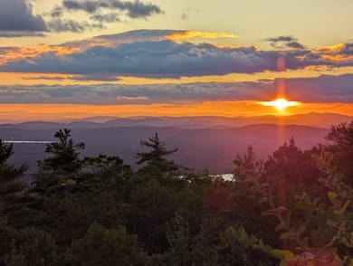 Sunset over the Lakes Region — where the palette came from.